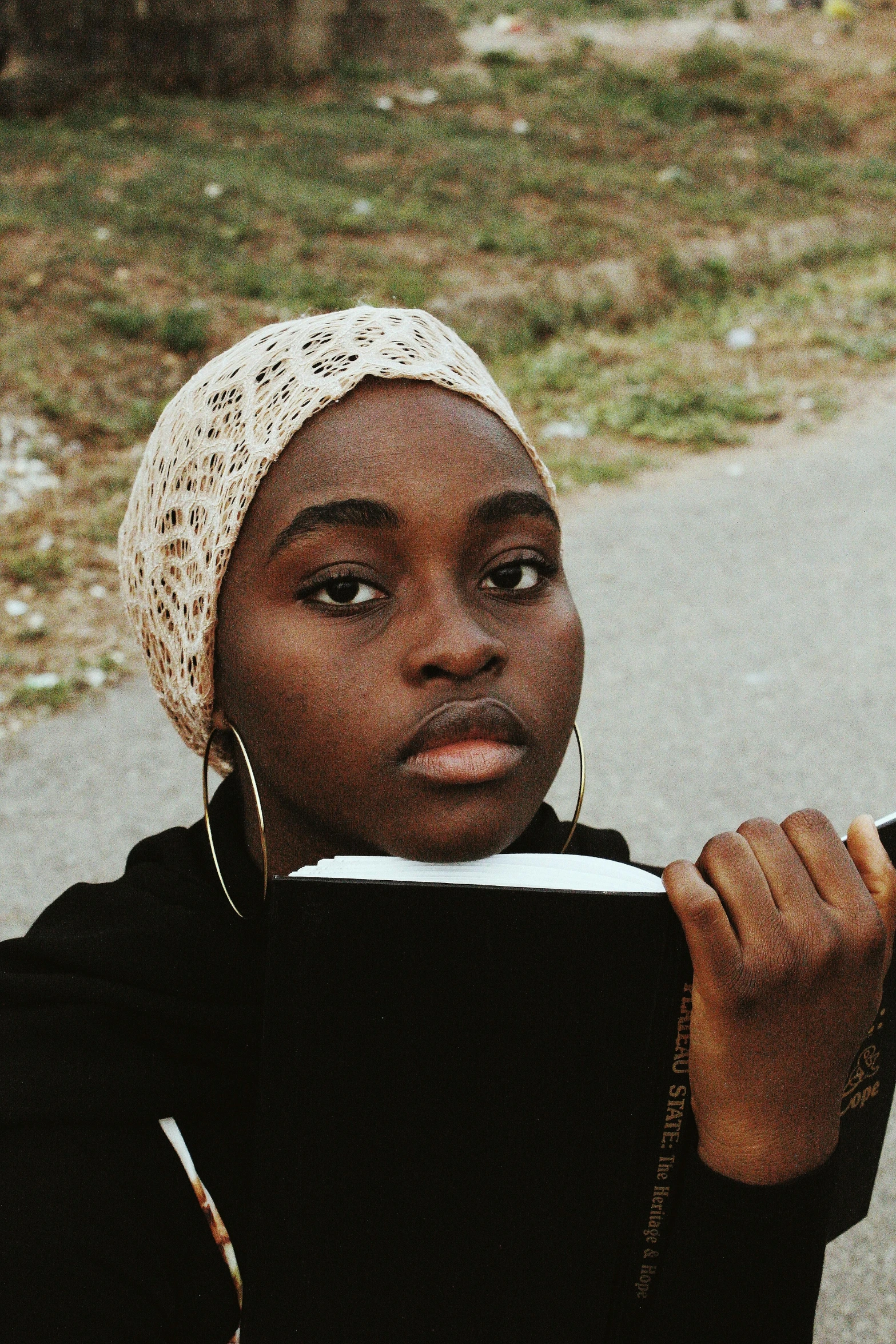 an african american woman in a white bonnet with a black book