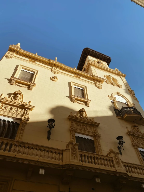 the facade of an elegant yellow building in france