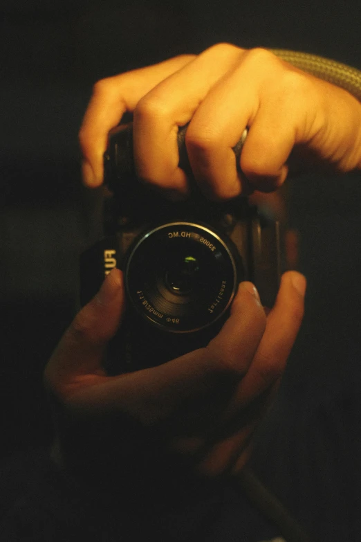 a person is holding up their camera with both hands