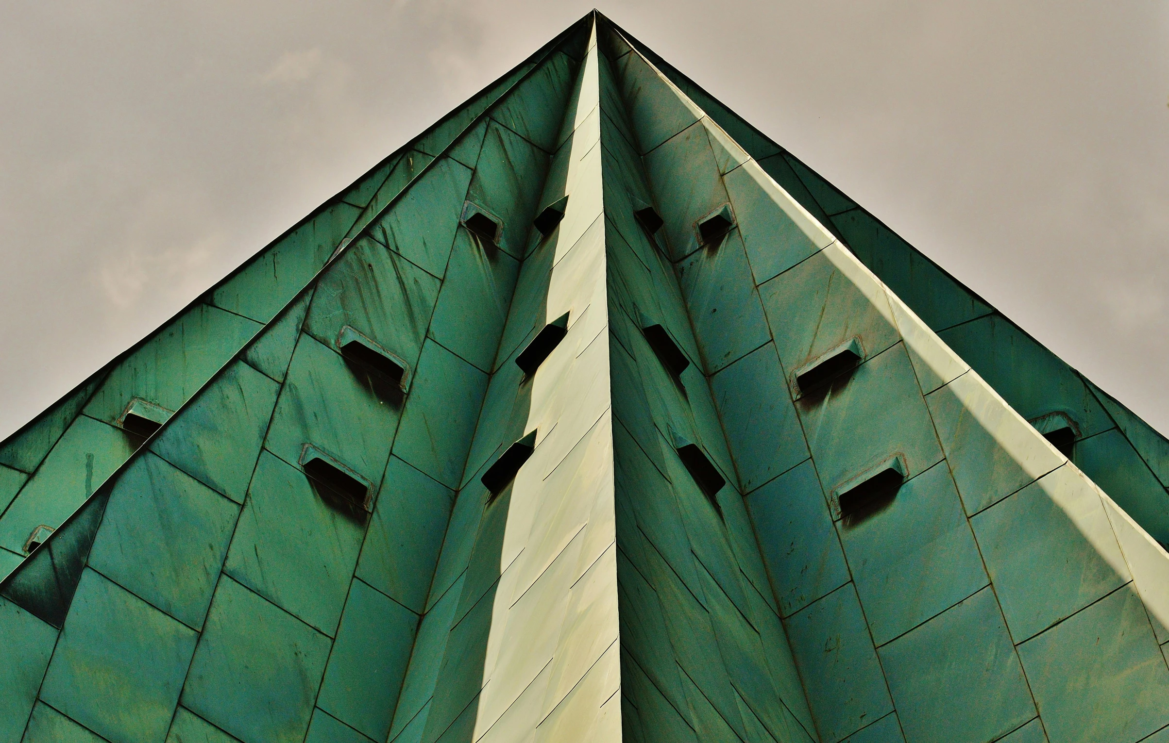 a green church steep with holes in it