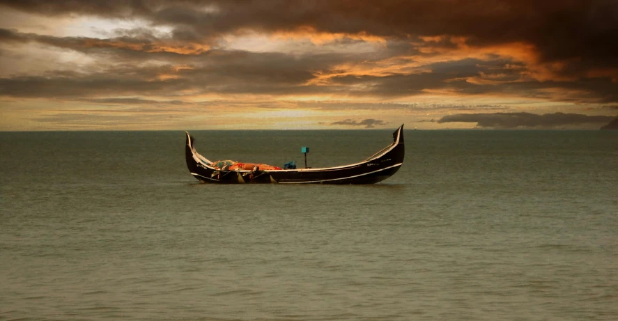 the boat is on the water under dark clouds