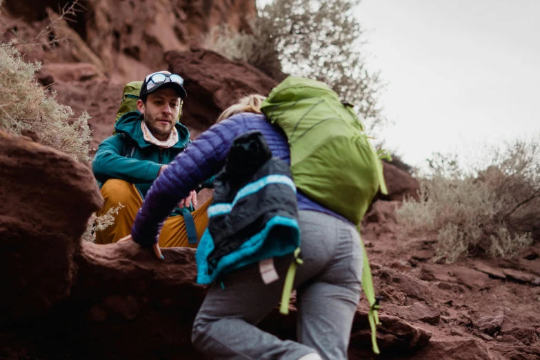 a group of people with backpacks on a mountain