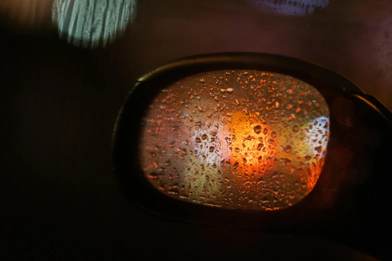 the side mirror of a car as seen through wet wipes