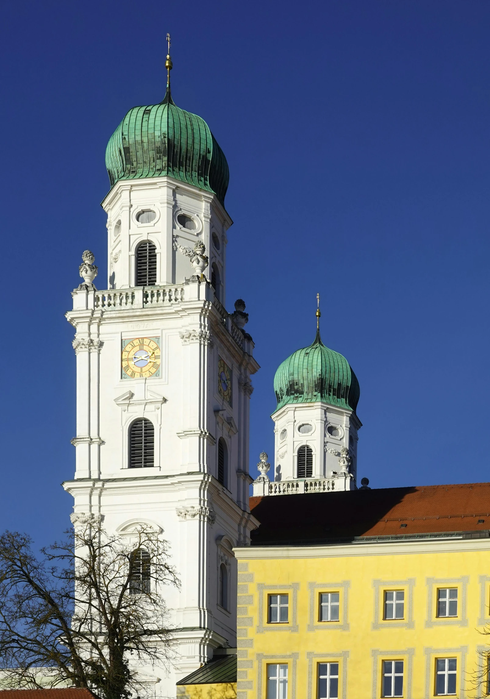 the spires on two buildings against the sky