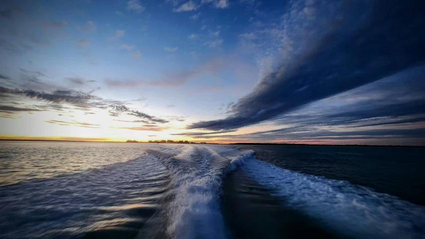 an image of the sunset taken from a boat