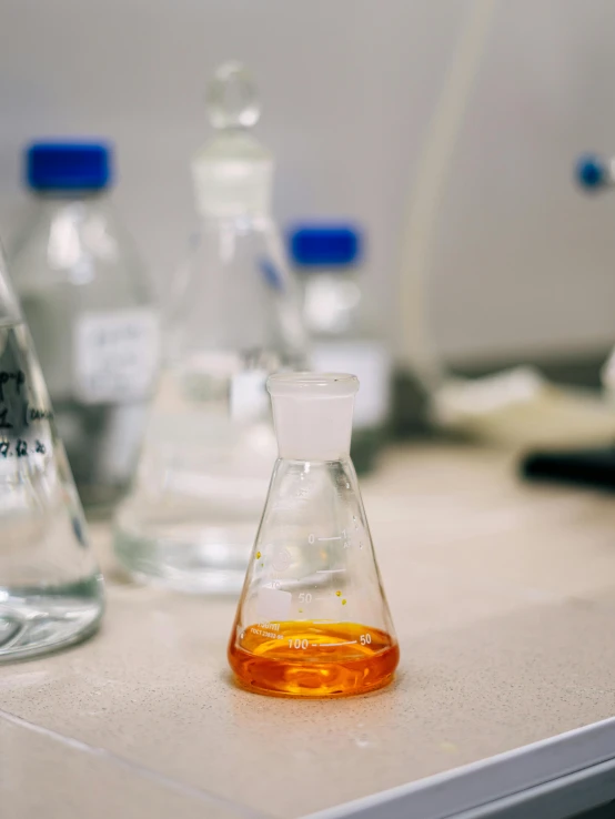 glass bottles are sitting on a counter with soing inside of them