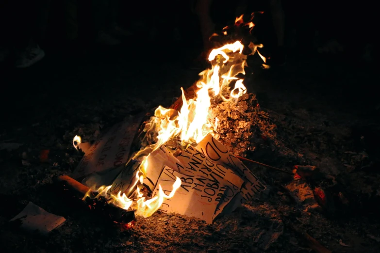 some signs in the middle of a bunch of burning material