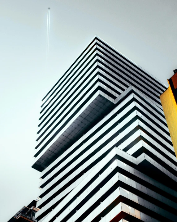 a black and white building with some cranes next to it