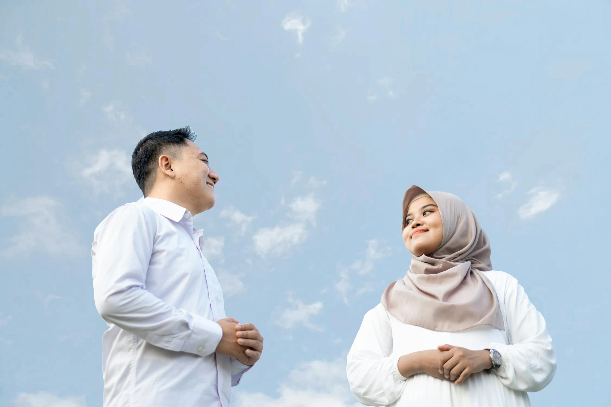 two people standing next to each other while wearing hijabs