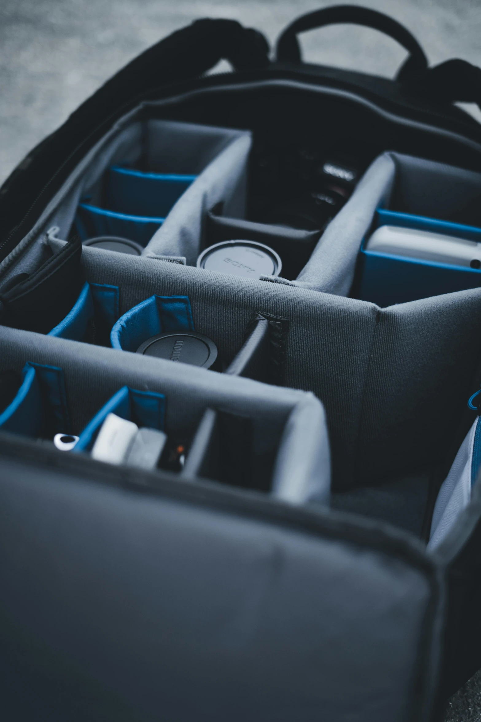 several compartments in a black and gray suit case