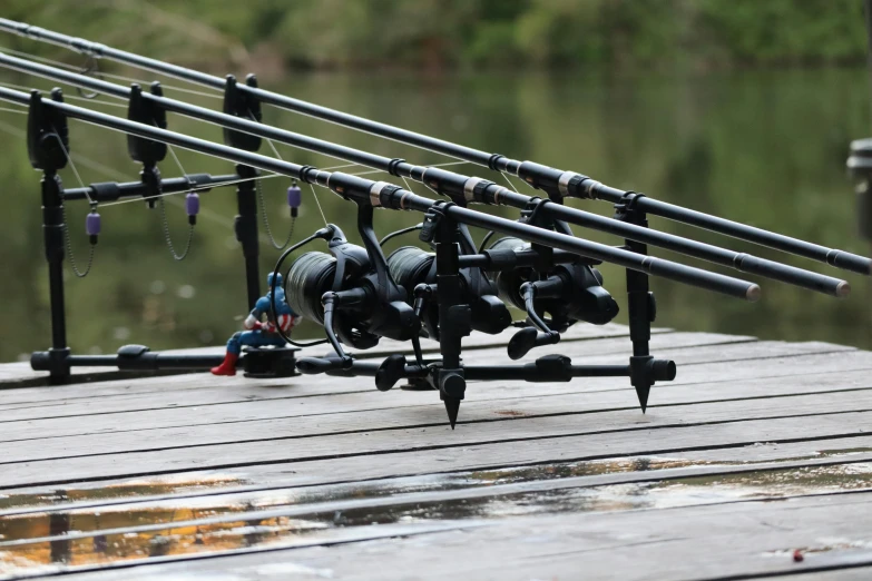 fishing rods and hooks are set on a wooden plank