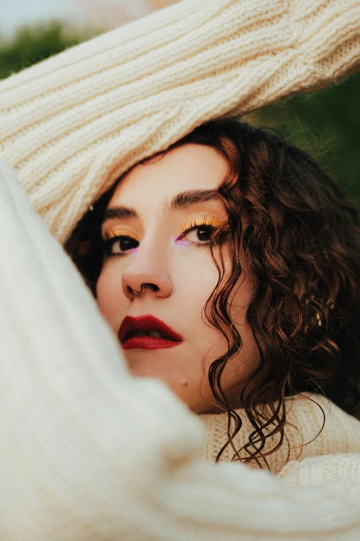 a woman with colorful makeup in white and green