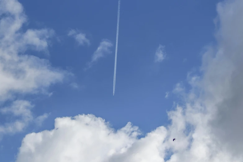 an airplane is flying in a blue sky