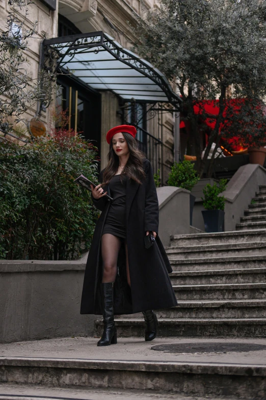 a woman wearing a red hat and black coat