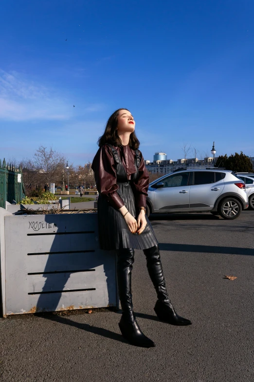 a young woman sits on a concrete bench