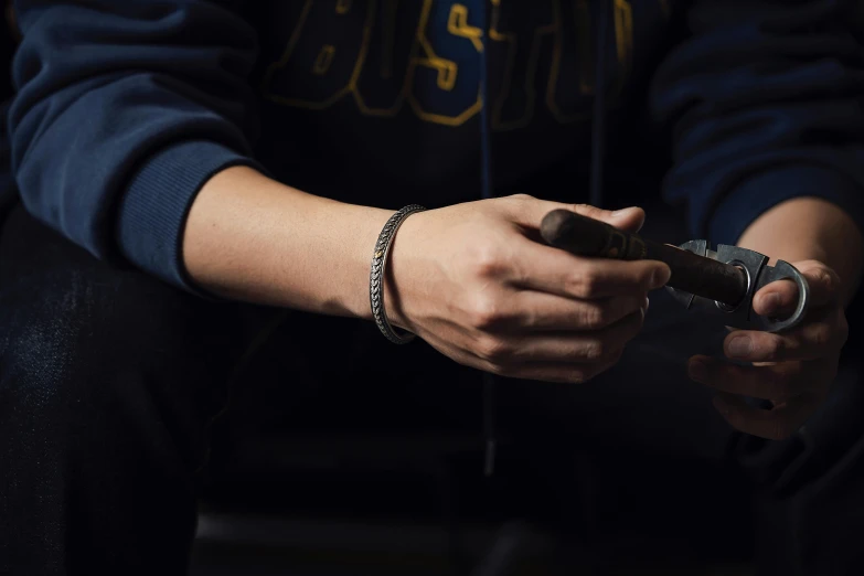 a man sitting down holding onto his cell phone