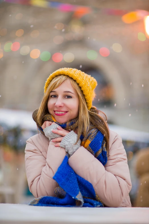 a woman with a yellow and blue scarf posing for a po