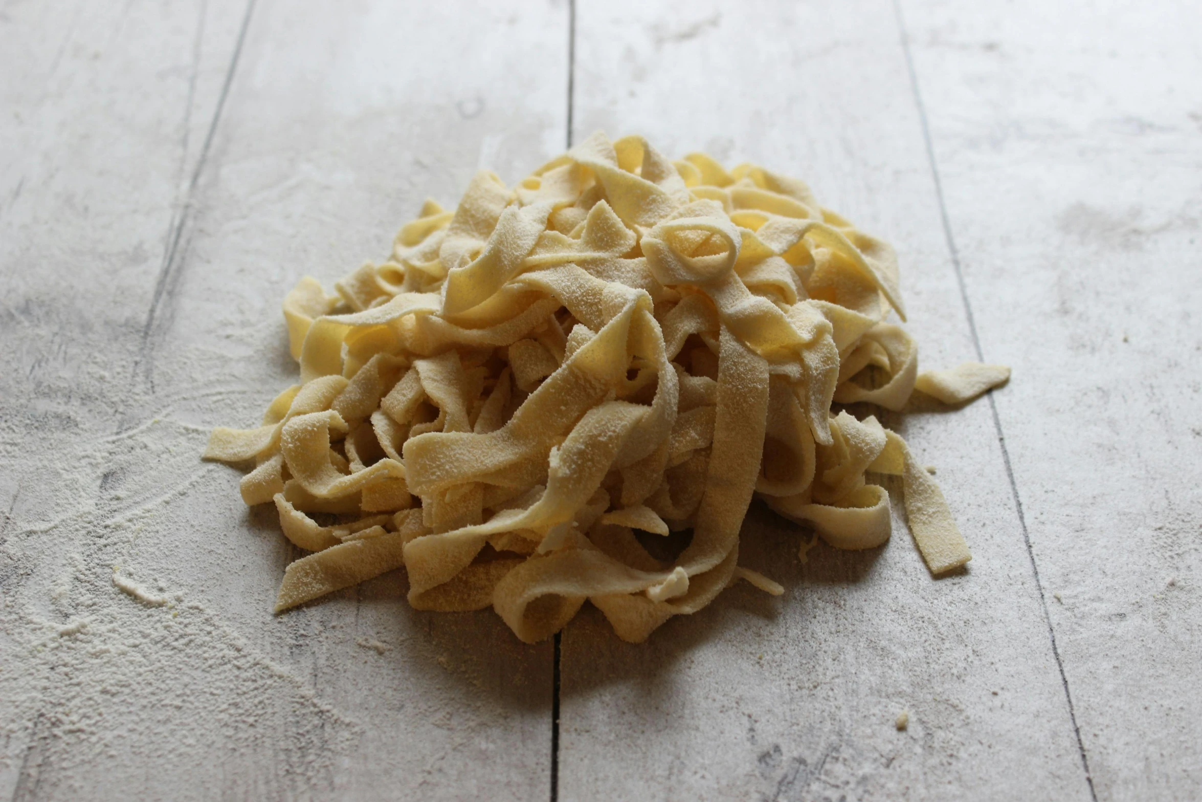 a pile of raw pasta on top of a table