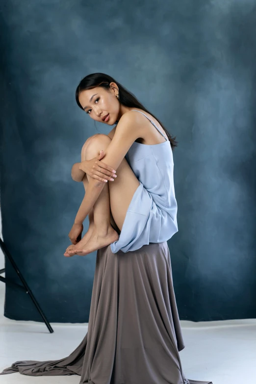 a woman in an evening dress holds the arm of a young man