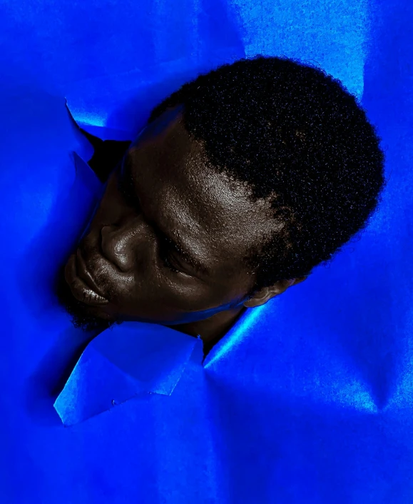 a black man's head in a blue background