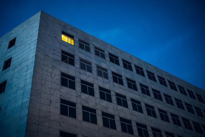 looking up at a large building with windows