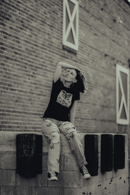 a boy is sitting on a concrete block outside