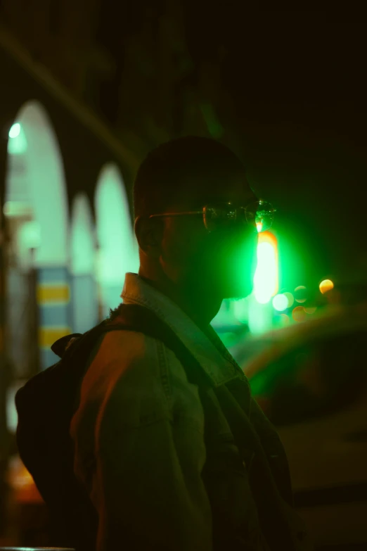 a man in a hat standing on the side walk