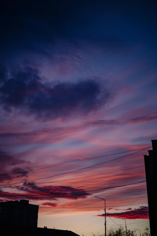 a sky is set at dusk with power lines above it