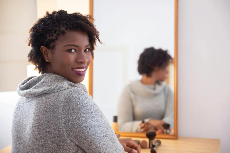 a woman is posing in front of a mirror in the reflection of her