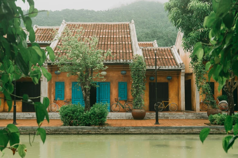 an image of a house with green doors and a blue window