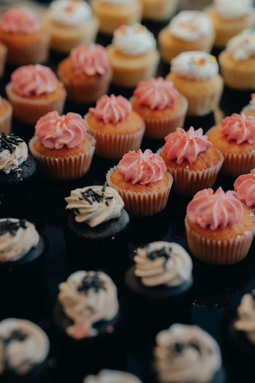 some cupcakes are lined up in an arrangement