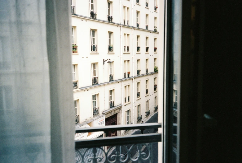 the view of a large building from inside an apartment building