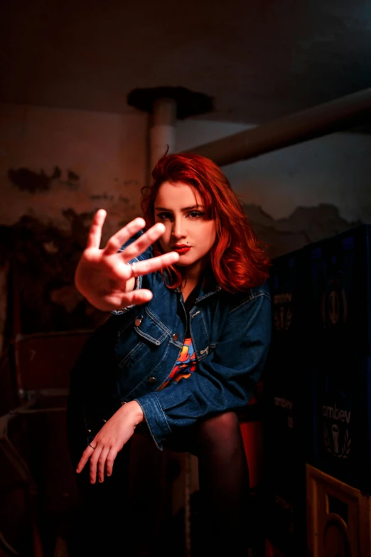 a woman in a jean shirt sitting on a chair