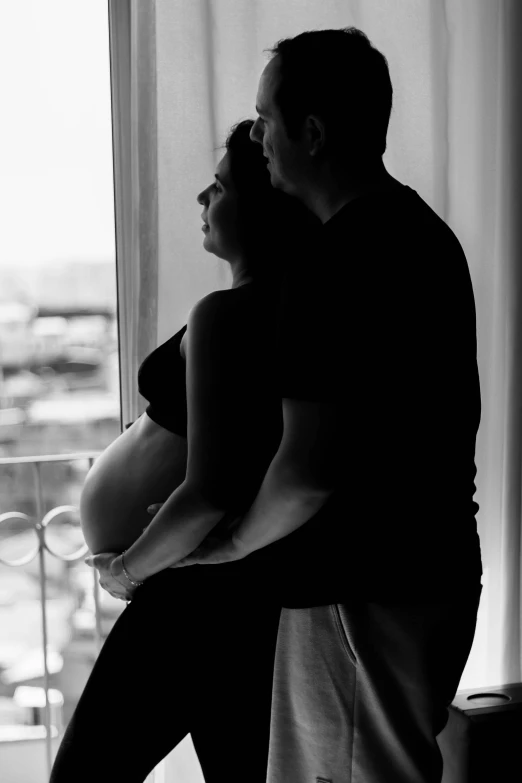 a black and white po of a man and woman posing