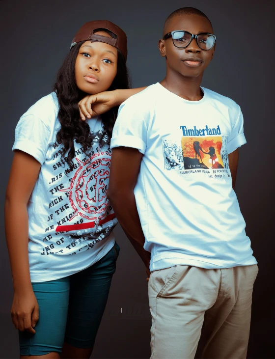 two people standing close together in t - shirts