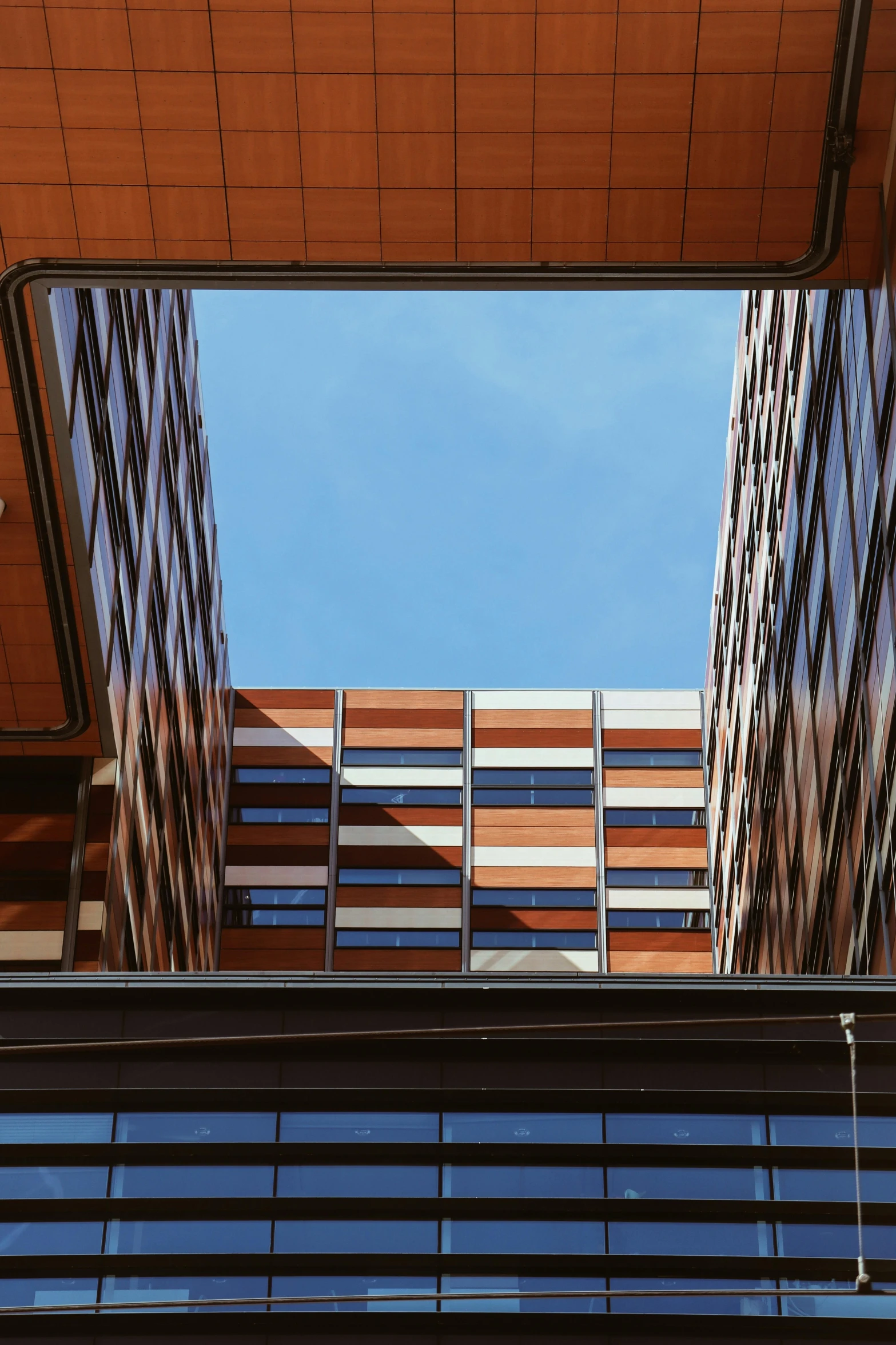 the view from underneath an apartment building with skyscrs in the background