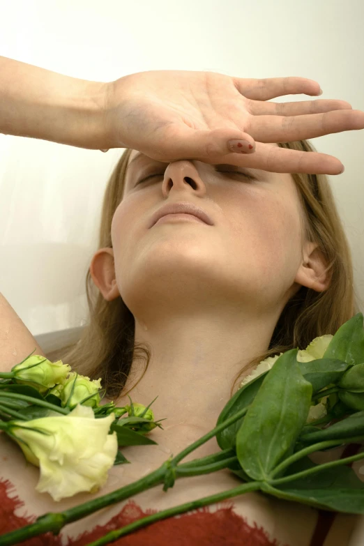 a woman holding up her flower crown