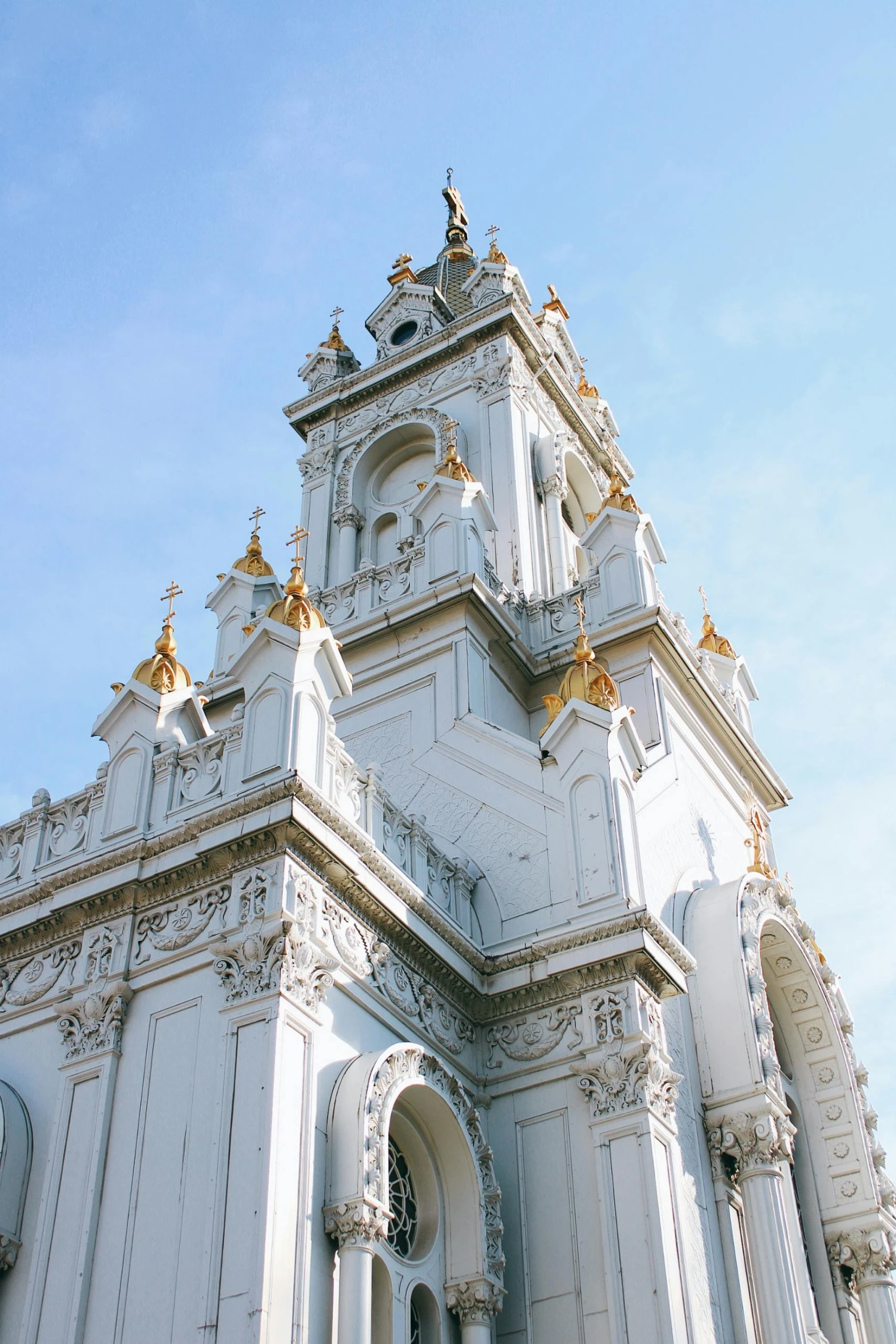 a white ornate structure with clocks on it