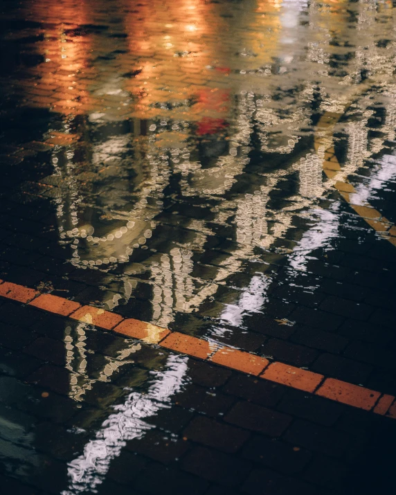 the reflection of several buildings on wet ground
