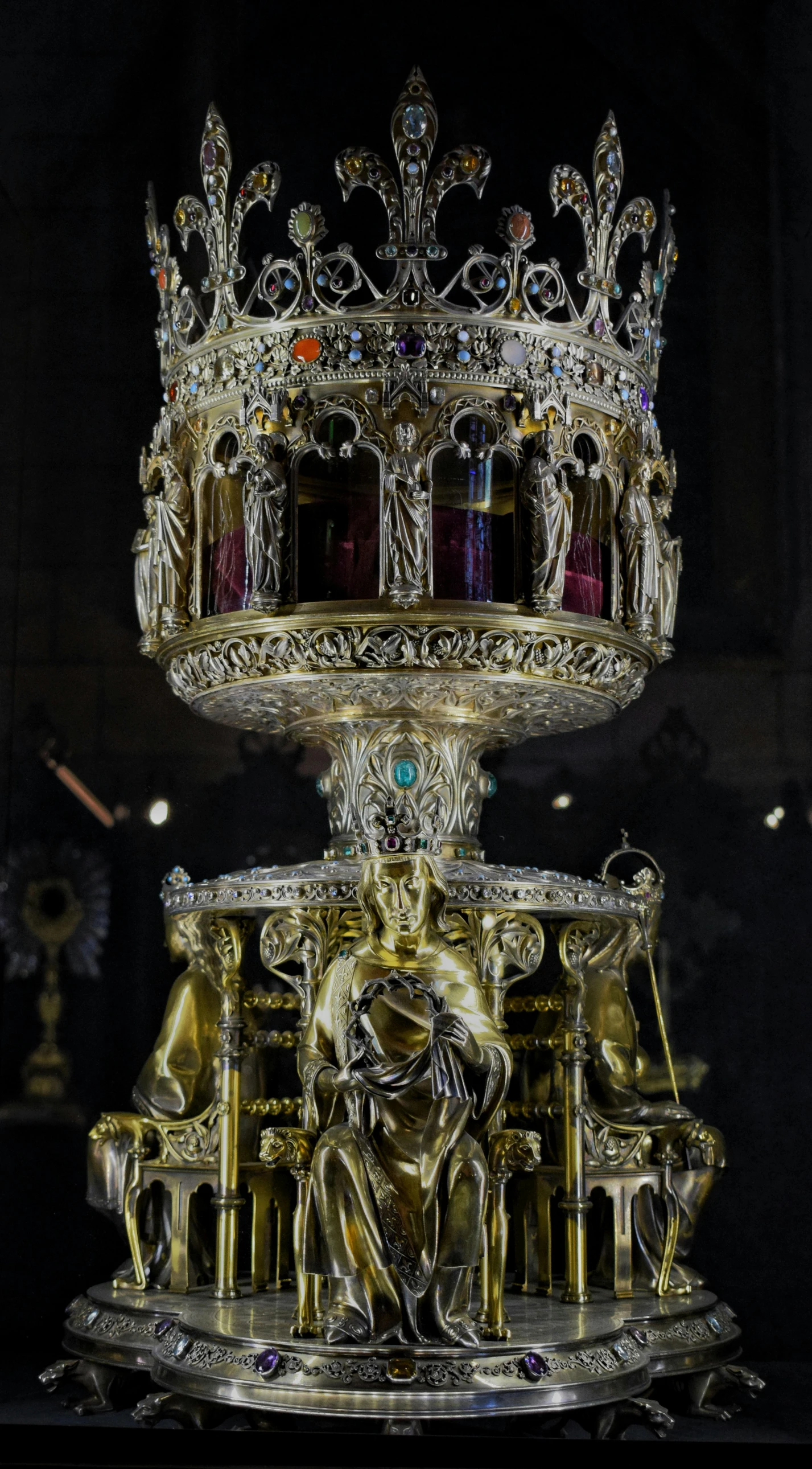 gold and crystal sculpture with the body of the man with arms extended