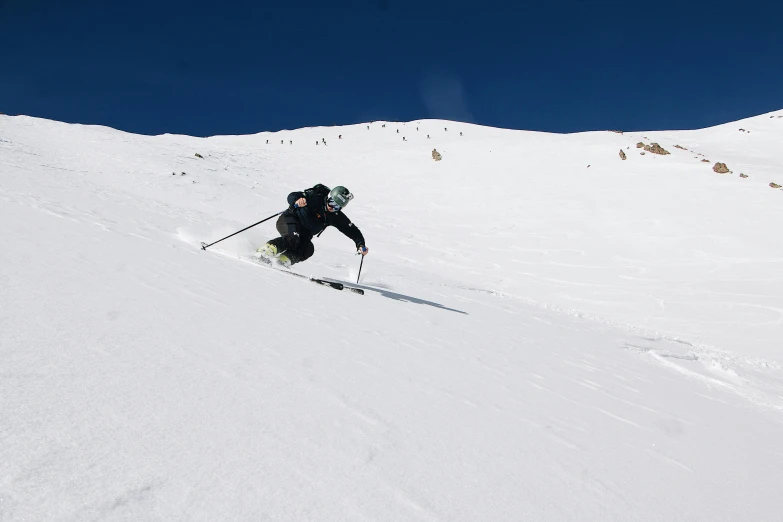 a man is skiing down a snowy mountain