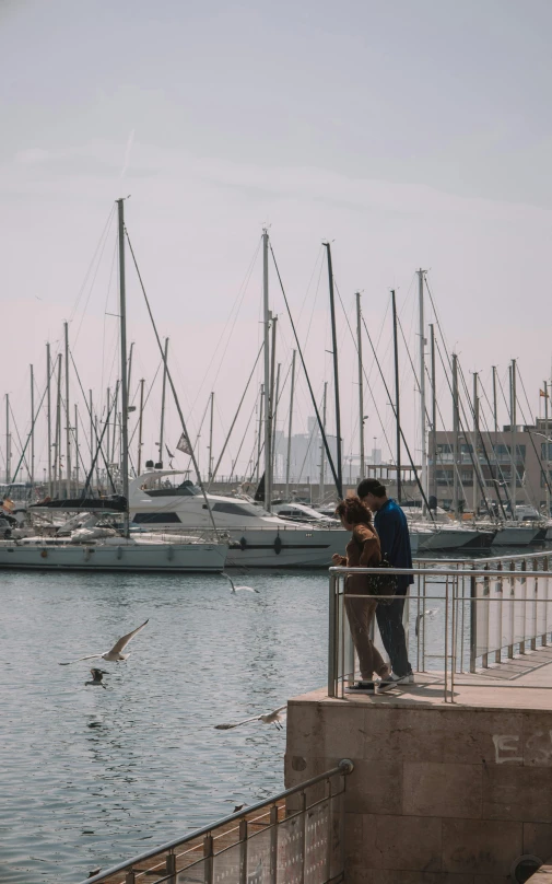 a man and woman kissing near the water