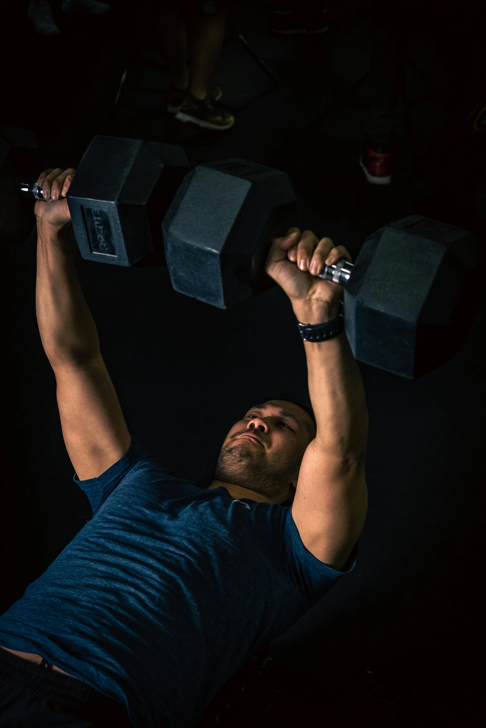 an image of a man working out with dumbbells