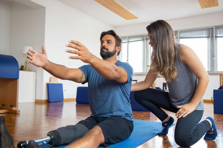 the man and woman are in a yoga class