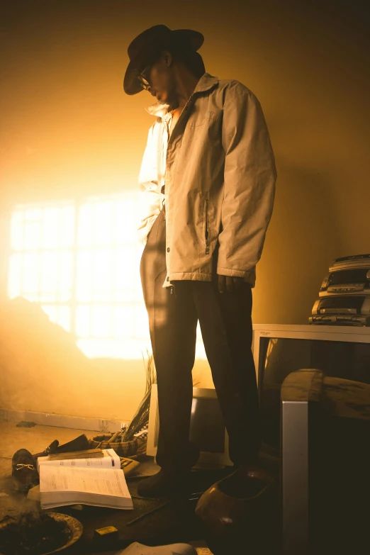 a man standing by an overturned desk full of junk