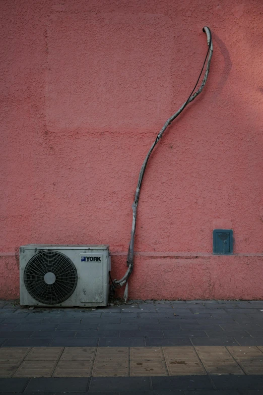 a wall with a air conditioner attached to it