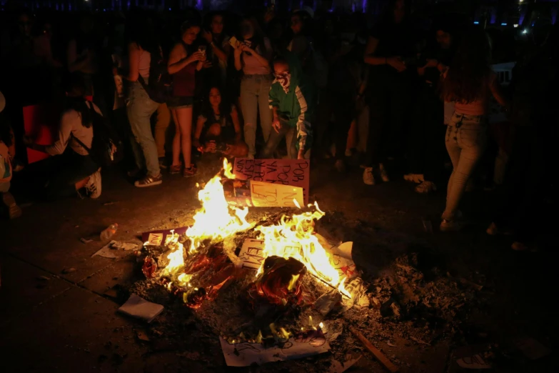 a group of people gathered around a fire pit