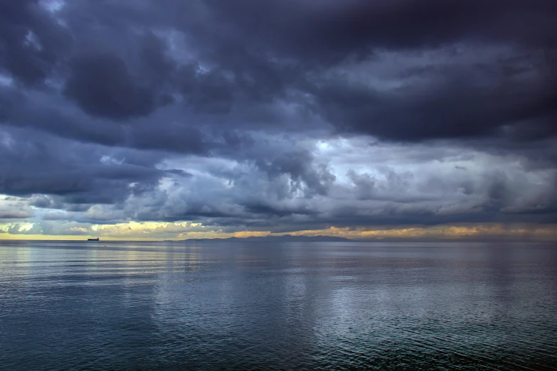 stormy skies reflect on the water beneath dark clouds