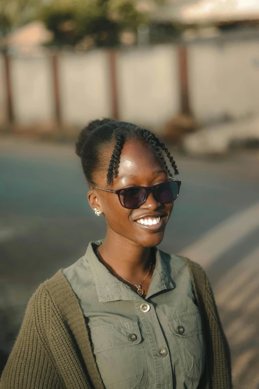 woman in green blouse with sunglasses on her head