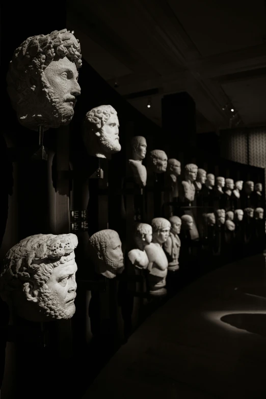 black and white image of many heads stacked on a rack